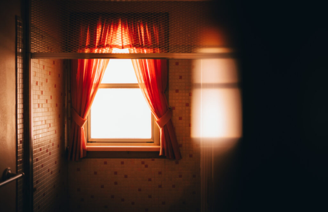 Image of a shower window with reflection off mirror. Image was created to replicate a horror movie.