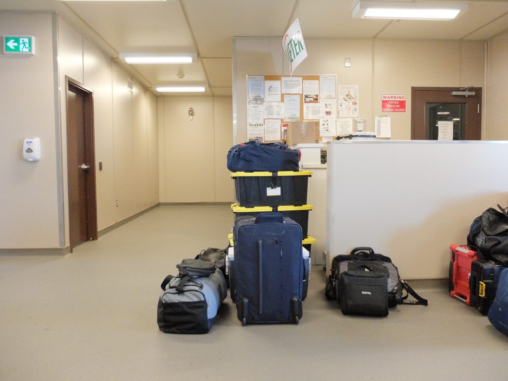 Image taken inside of Lac Brochet airport showing stacks of luggage waiting to board the plane back to Winnipeg.