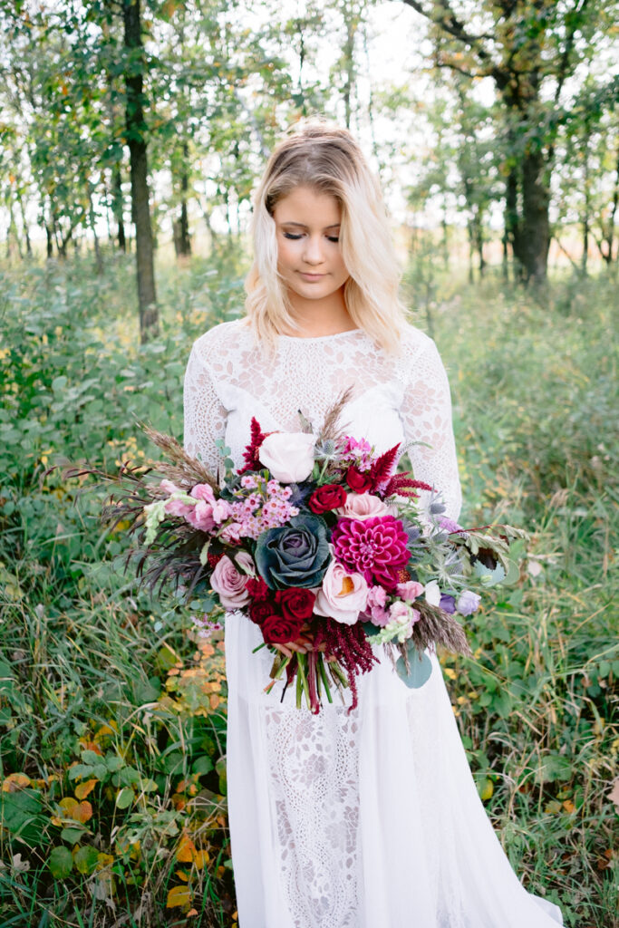 A bride in a white dress holding a bouquet of flowers