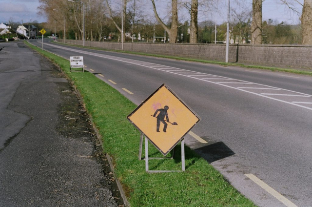 35mm film image of a roadworks sign on a grassy verge in Moate, Co.Westmeath